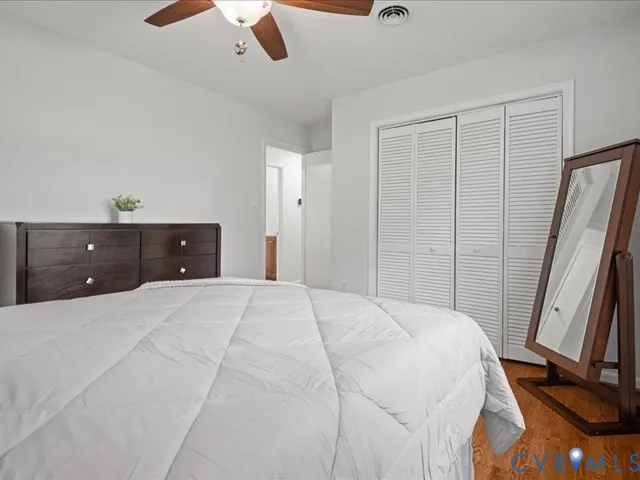 a bedroom with a bed and a dresser