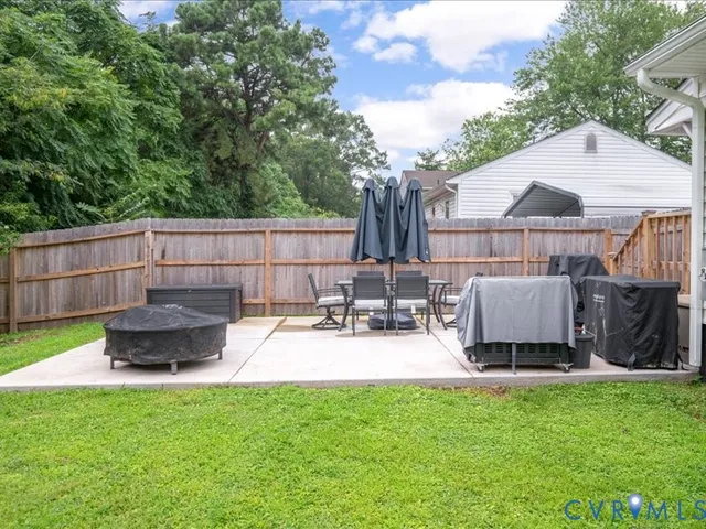 a view of a backyard with a sitting area and furniture