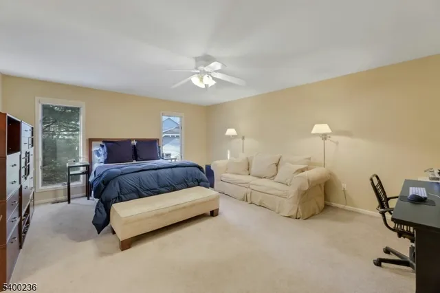 a spacious bedroom with a bed and a flat screen tv