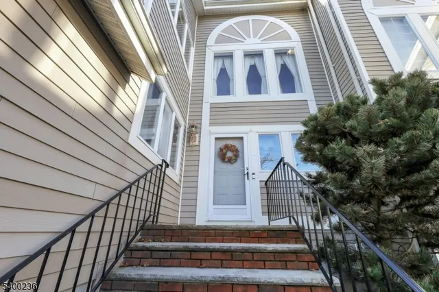 a view of building with wooden stairs and a potted plant