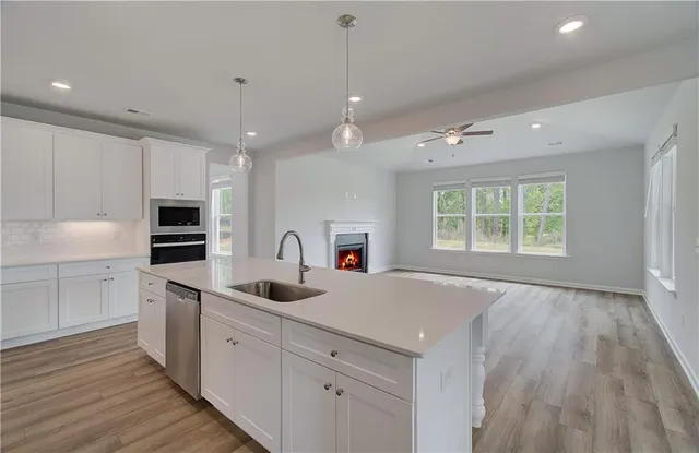 a kitchen with sink cabinets and refrigerator