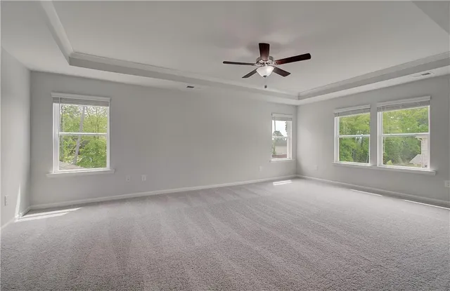 a view of a livingroom with a ceiling fan and window