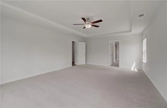 a spacious bathroom with a double vanity sink a mirror and a bathtub