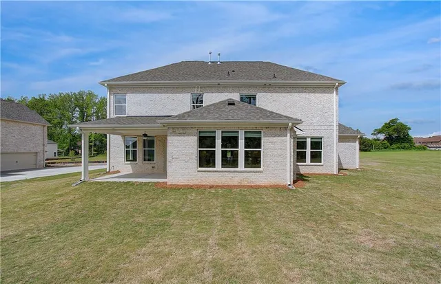 a front view of a house with a garden