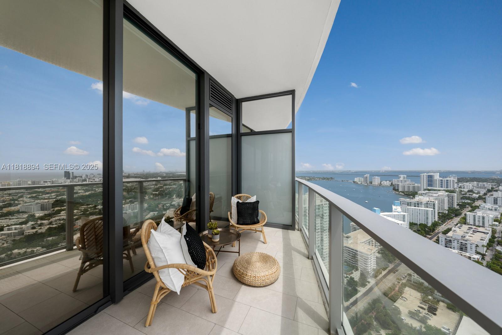 500 Alton Road, Unit 4004 Miami Beach, FL 33139 - Photo 12 of 26 a balcony with furniture and a ocean view