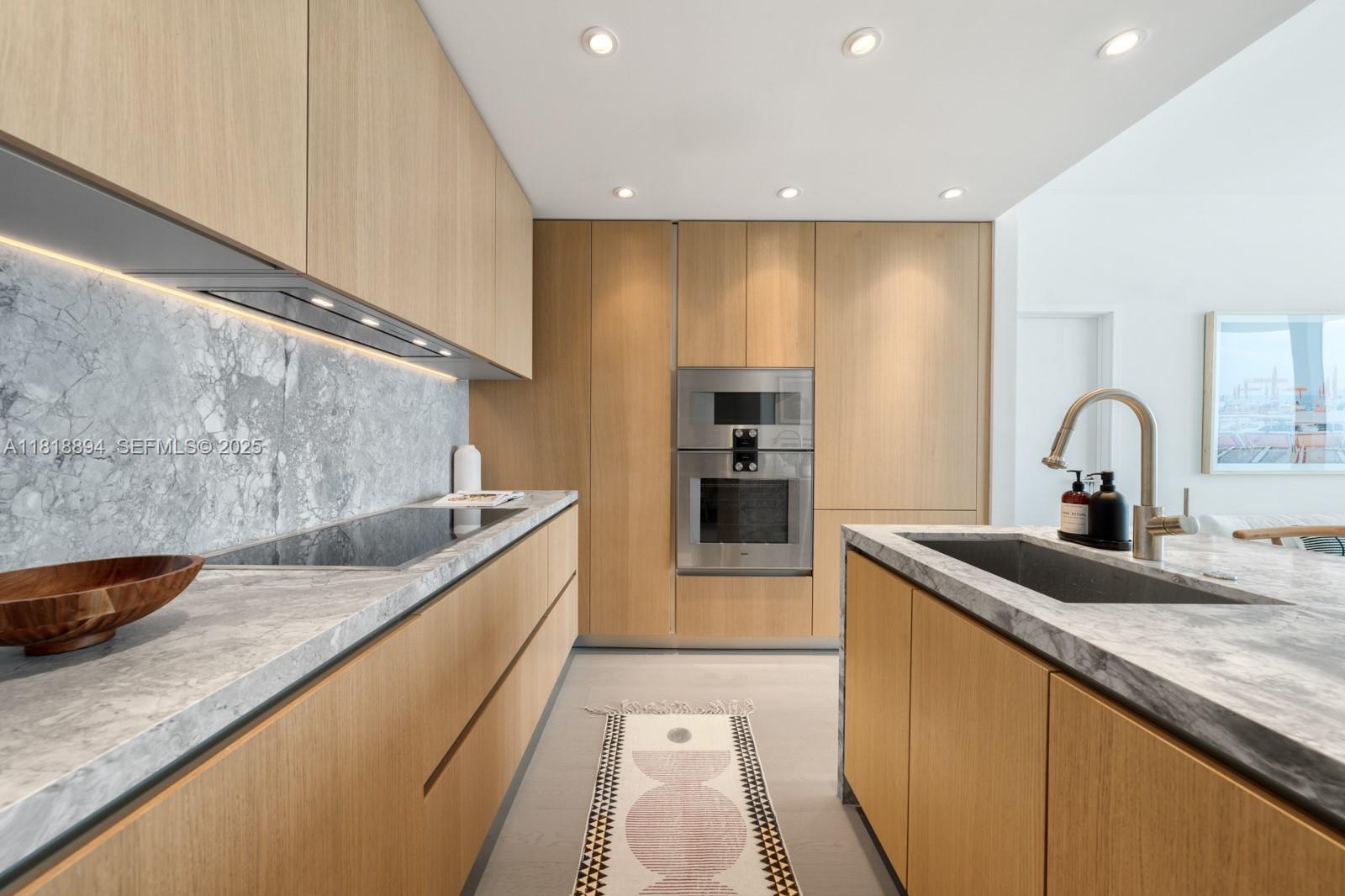 500 Alton Road, Unit 4004 Miami Beach, FL 33139 - Photo 4 of 26 a kitchen with stainless steel appliances granite countertop a sink and a stove