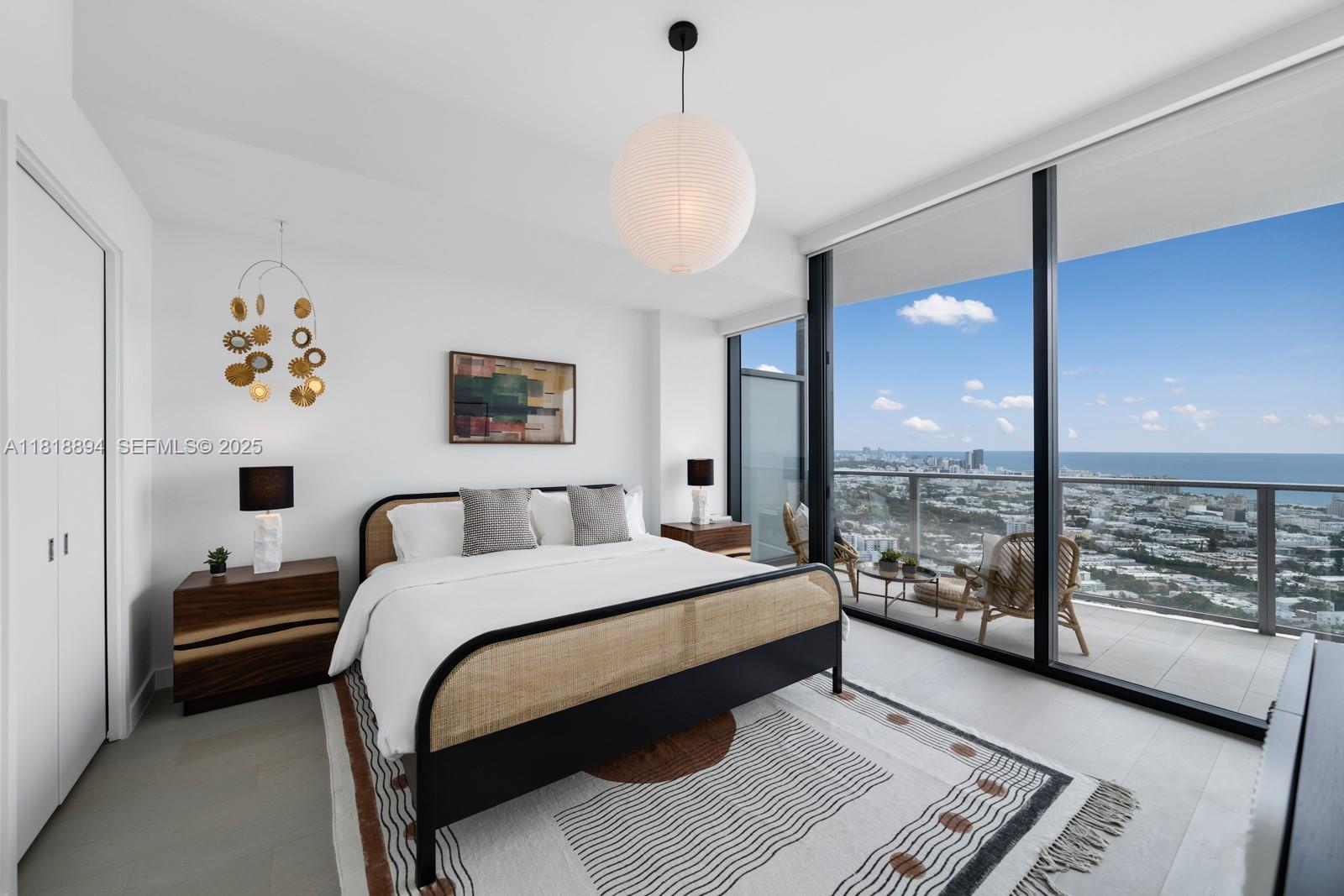 500 Alton Road, Unit 4004 Miami Beach, FL 33139 - Photo 8 of 26 a bedroom with a bed painting on wall and a large window