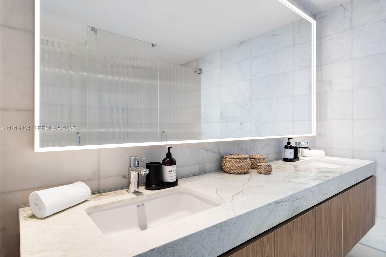 500 Alton Road, Unit 4004 Miami Beach, FL 33139 - Photo 10 of 26 a bathroom with a sink and a mirror