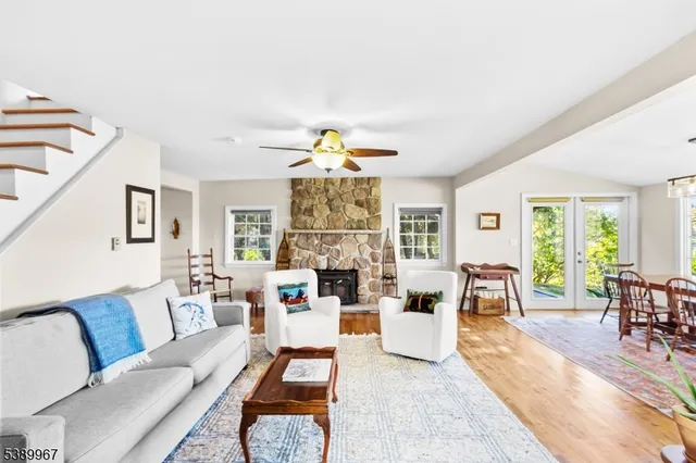 a living room with fireplace furniture and a large window