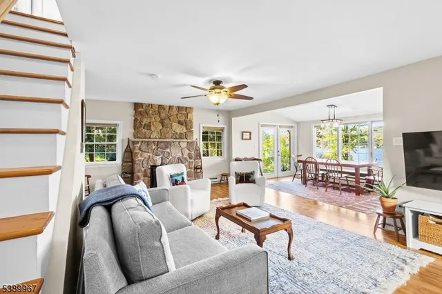 a living room with furniture a flat screen tv and a large window