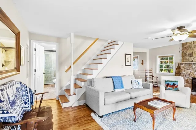 a living room with furniture and a book shelf