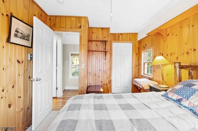 a bedroom with a bed next to a window with the outer view