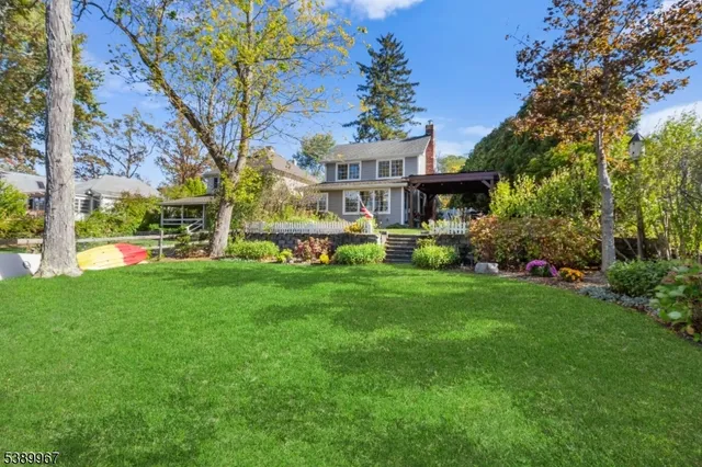 a front view of a house with a yard table and chairs