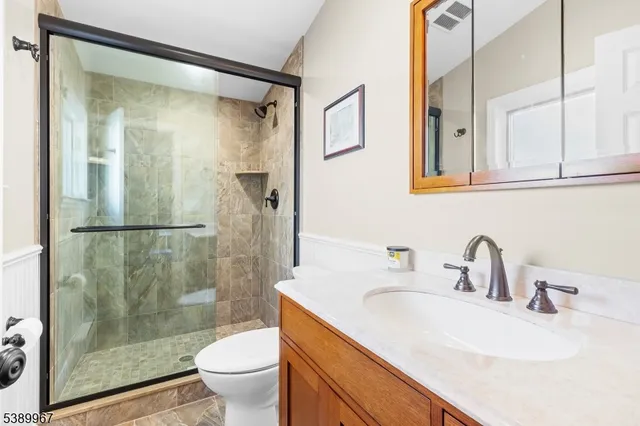 a view of a patio with table and chairs under an umbrella with a big yard