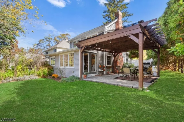 a view of a backyard with table and chairs and a patio