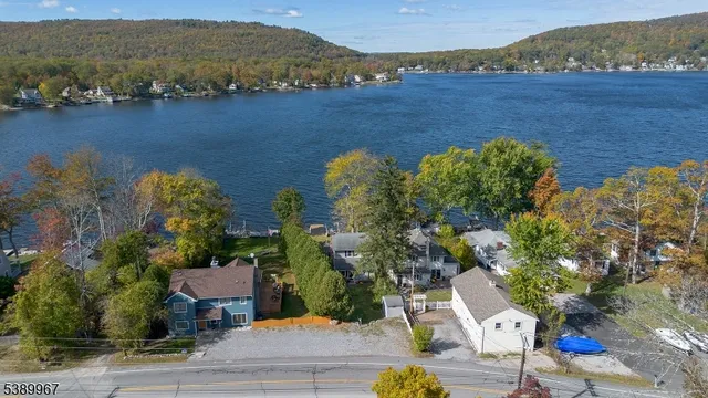an aerial view of a house with a lake view