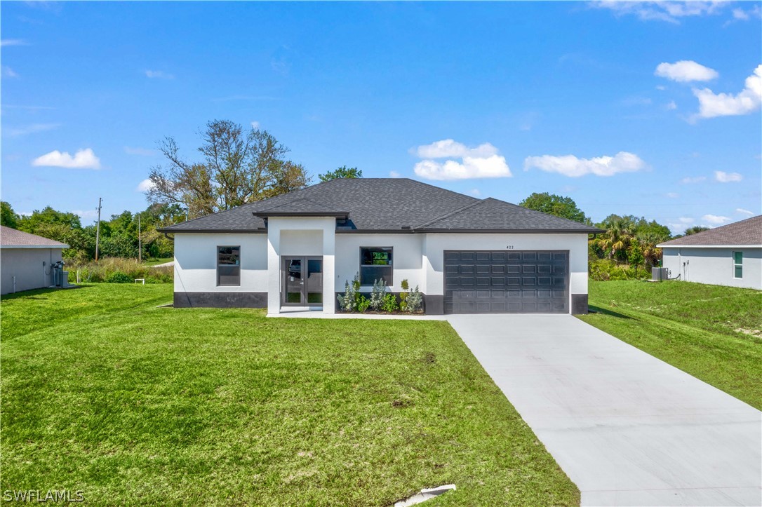 a front view of a house with a yard and garage