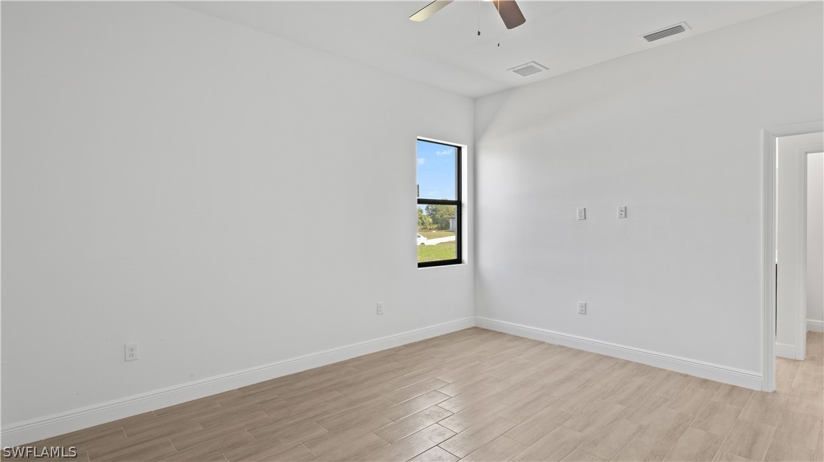 422 Progress Avenue Lehigh Acres, FL 33974 - Photo 16 of 35 an empty room with a window