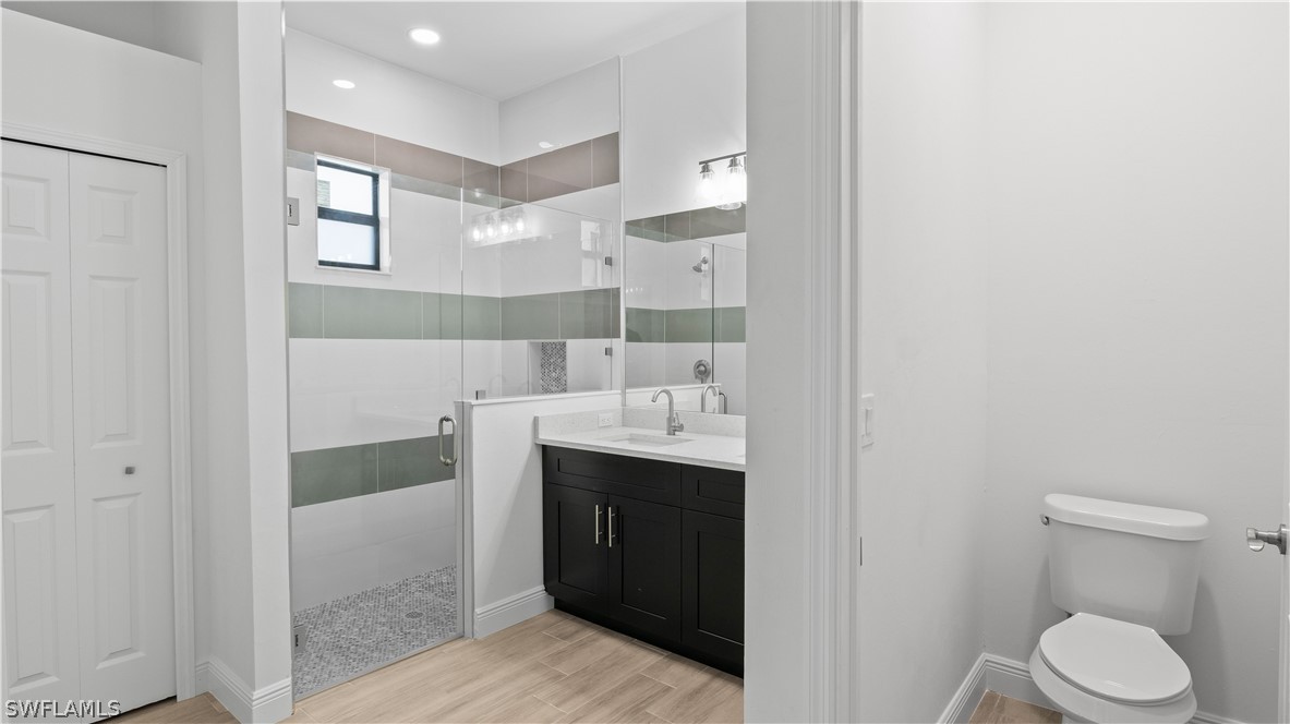 422 Progress Avenue Lehigh Acres, FL 33974 - Photo 17 of 35 a bathroom with a sink and mirror