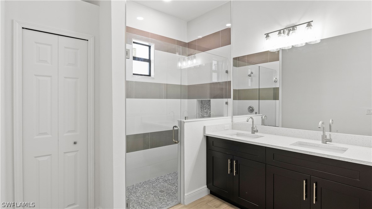 422 Progress Avenue Lehigh Acres, FL 33974 - Photo 18 of 35 a bathroom with a double vanity sink mirror and double