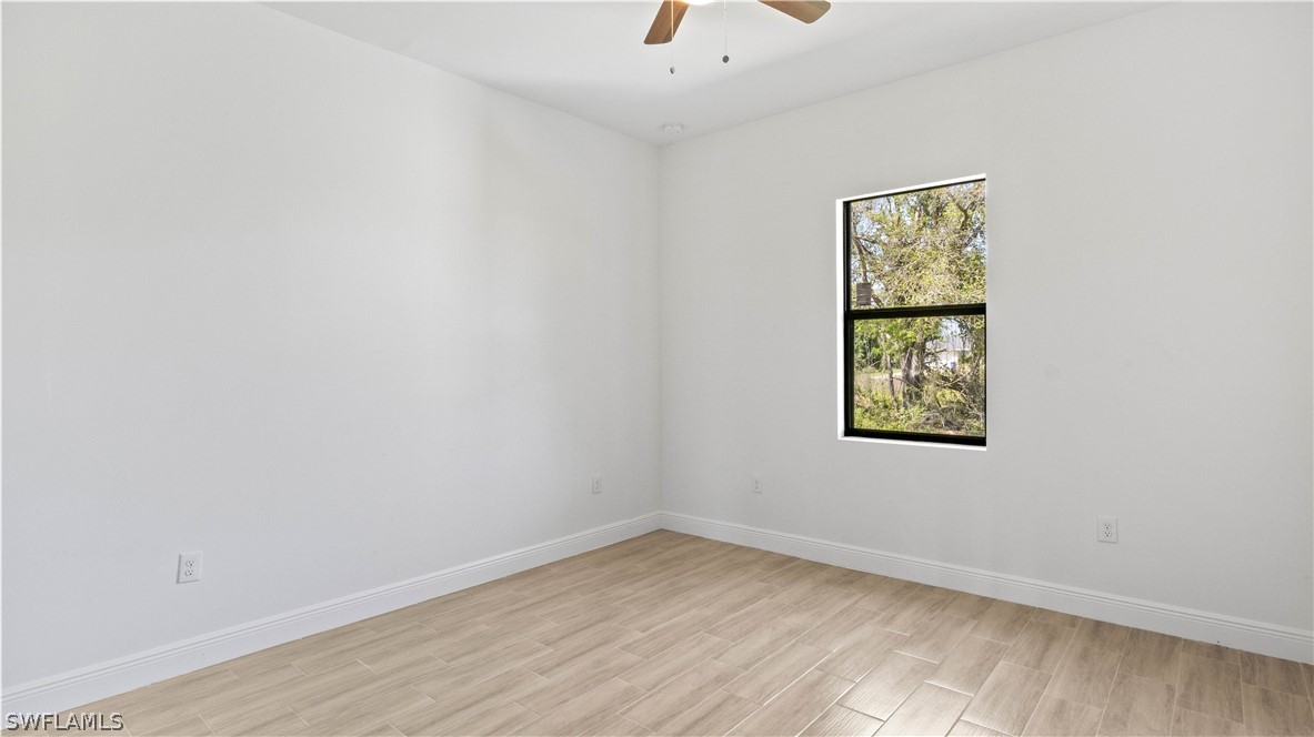 422 Progress Avenue Lehigh Acres, FL 33974 - Photo 19 of 35 an empty room with a window