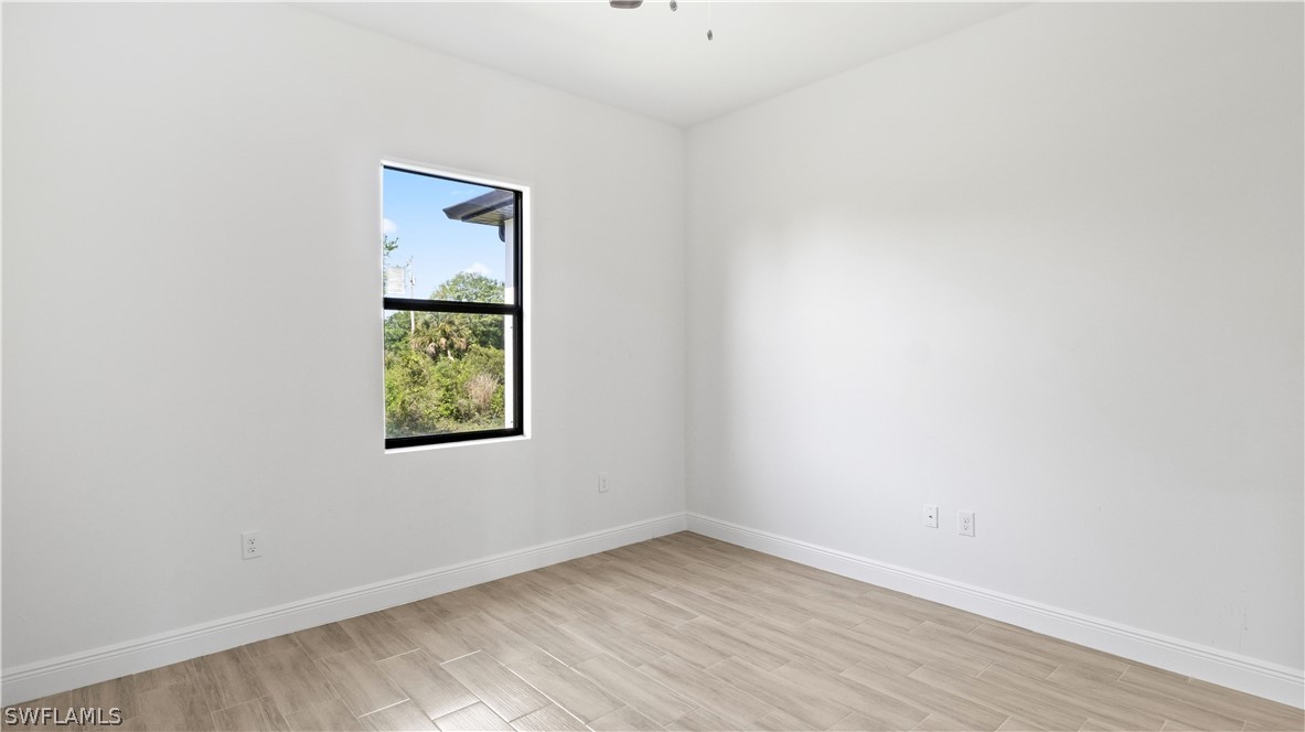422 Progress Avenue Lehigh Acres, FL 33974 - Photo 22 of 35 an empty room with a window