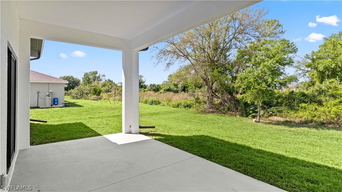 422 Progress Avenue Lehigh Acres, FL 33974 - Photo 29 of 35 a view of a house with a big yard