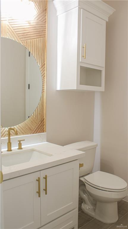 900 Azalea Street Mission, TX 78573 - Photo 10 of 12 Bathroom vanity featuring a quartz countertop, integrated sink, and gold-finish fixtures