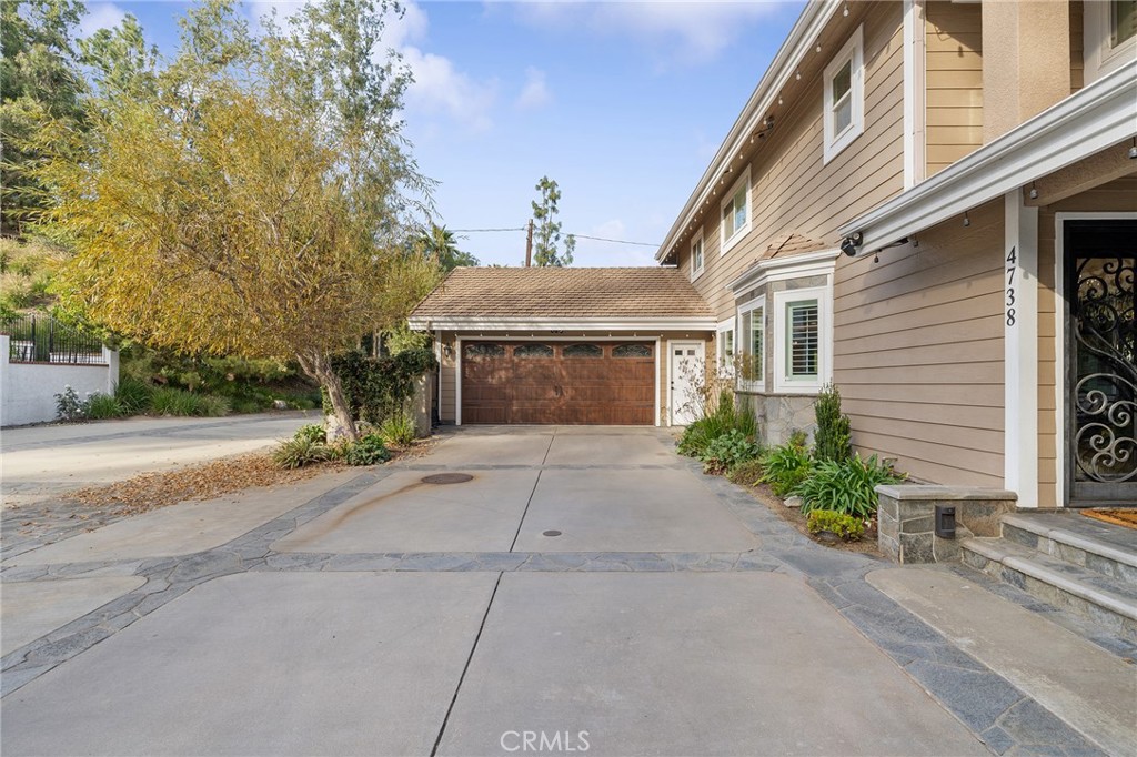 4738 Live Oak Canyon Road La Verne, CA 91750 - Photo 67 of 70 a front view of a house with a yard and a garage