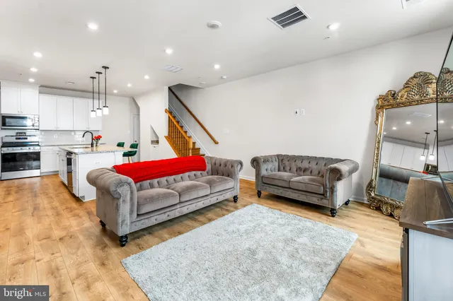 a living room with furniture and kitchen view