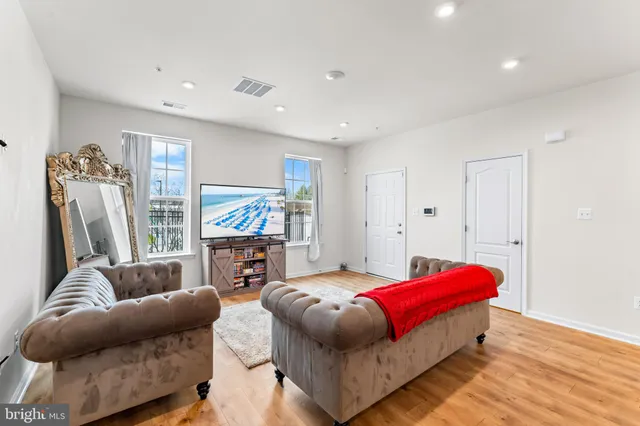 a bedroom with furniture and a flat screen tv