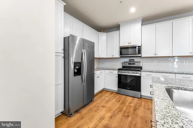 a kitchen with stainless steel appliances a refrigerator stove and sink