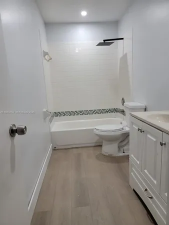 an empty room with windows and mirror