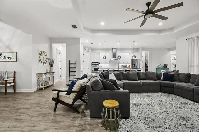 a living room with furniture and a wooden floor