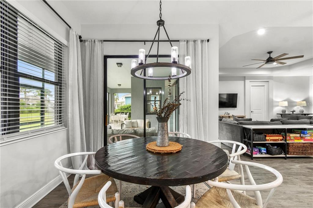 4423 Fly Rod Terrace Parrish, FL 34219 - Photo 26 of 89 a dining room with furniture a chandelier and wooden floor