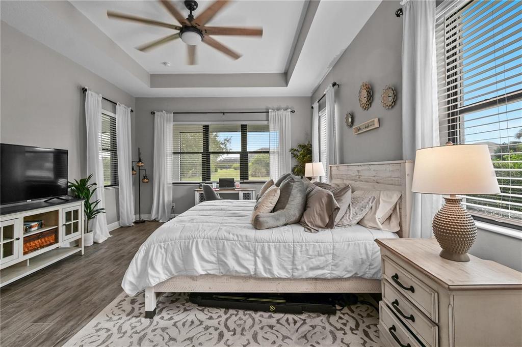 4423 Fly Rod Terrace Parrish, FL 34219 - Photo 31 of 89 a bedroom with a bed and a flat screen tv