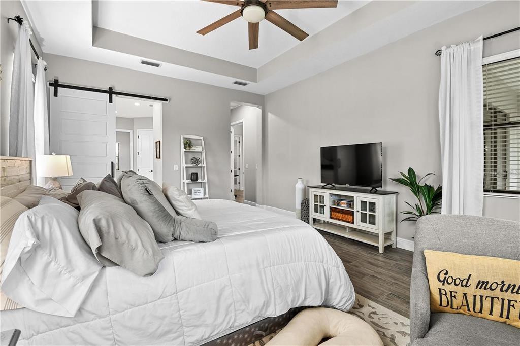 4423 Fly Rod Terrace Parrish, FL 34219 - Photo 33 of 89 a bedroom with a bed and a flat screen tv