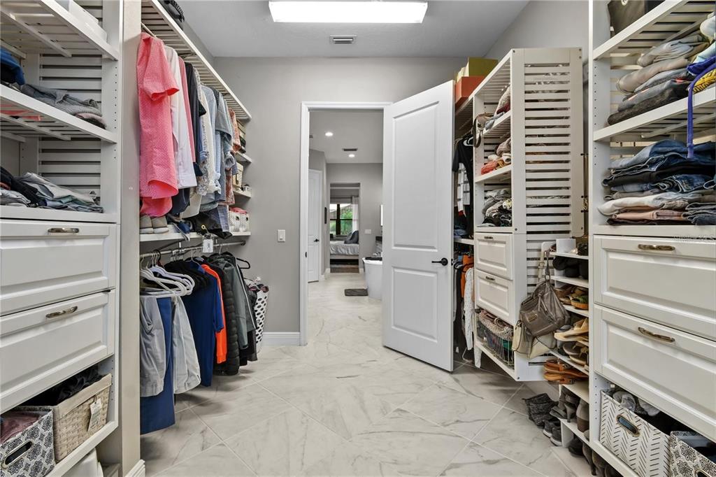 4423 Fly Rod Terrace Parrish, FL 34219 - Photo 37 of 89 a view of walk in closet with clothes and shoes