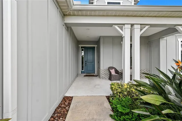 a large white kitchen with a large island oven a stove a sink a dining table and chairs