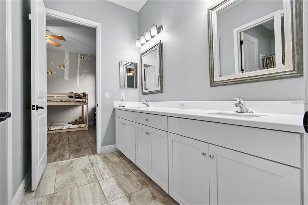 4423 Fly Rod Terrace Parrish, FL 34219 - Photo 43 of 89 a spacious bathroom with a sink and a mirror