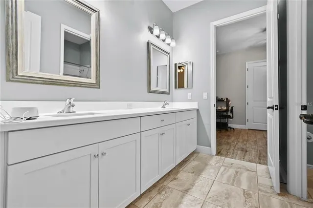 an aerial view of a city with lots of residential buildings ocean and mountain view in back