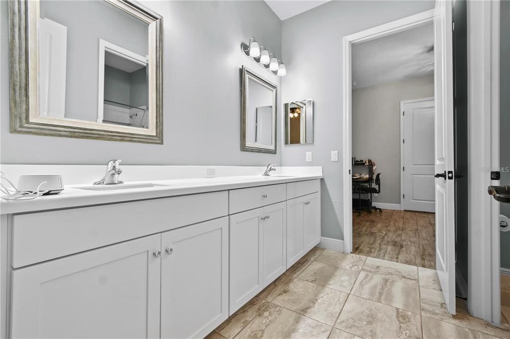 4423 Fly Rod Terrace Parrish, FL 34219 - Photo 44 of 89 a bathroom with a sink and a mirror