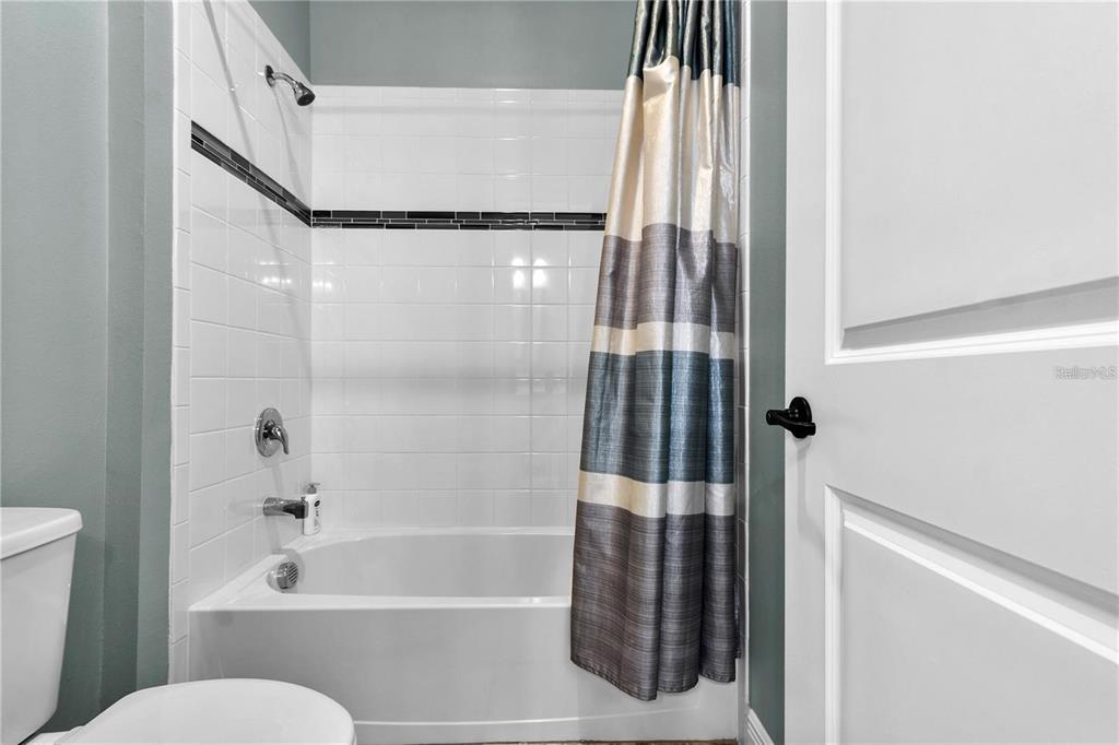 4423 Fly Rod Terrace Parrish, FL 34219 - Photo 45 of 89 a bathroom with a bathtub and a shower