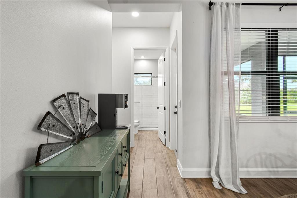 4423 Fly Rod Terrace Parrish, FL 34219 - Photo 48 of 89 a view of a livingroom with wooden floor and a hallway