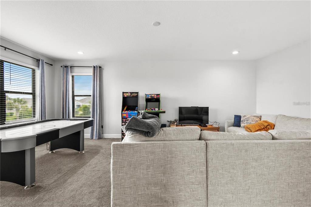 4423 Fly Rod Terrace Parrish, FL 34219 - Photo 60 of 89 a living room with furniture a flat screen tv and a window