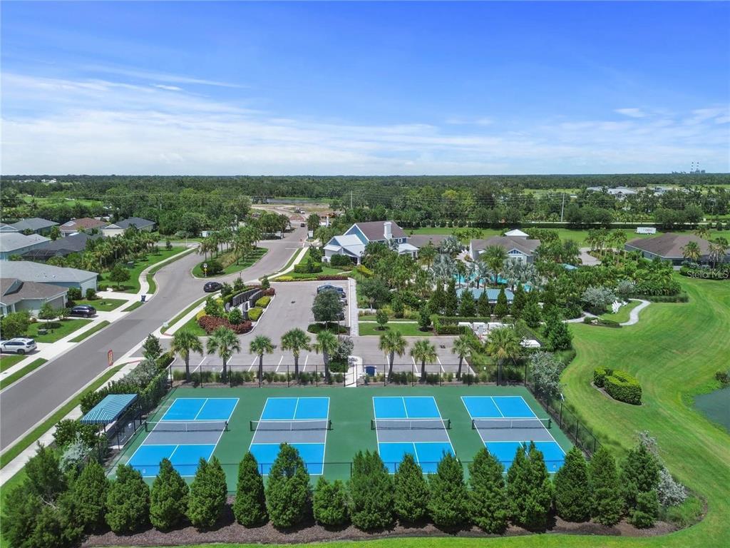 4423 Fly Rod Terrace Parrish, FL 34219 - Photo 75 of 89 an aerial view of a city with lots of residential buildings ocean and mountain view in back