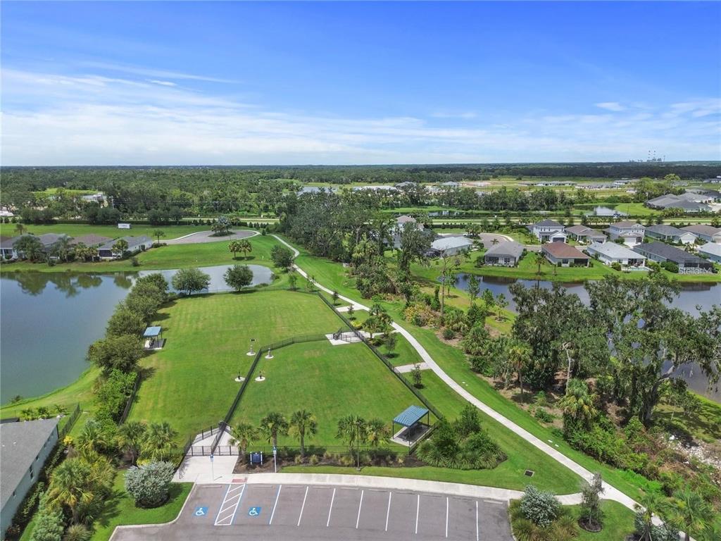 4423 Fly Rod Terrace Parrish, FL 34219 - Photo 77 of 89 an aerial view of lake with residential houses with outdoor space and swimming pool