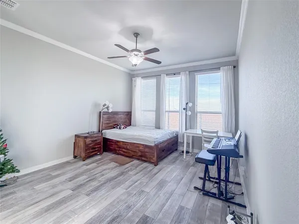 a bedroom with a bed and a chandelier