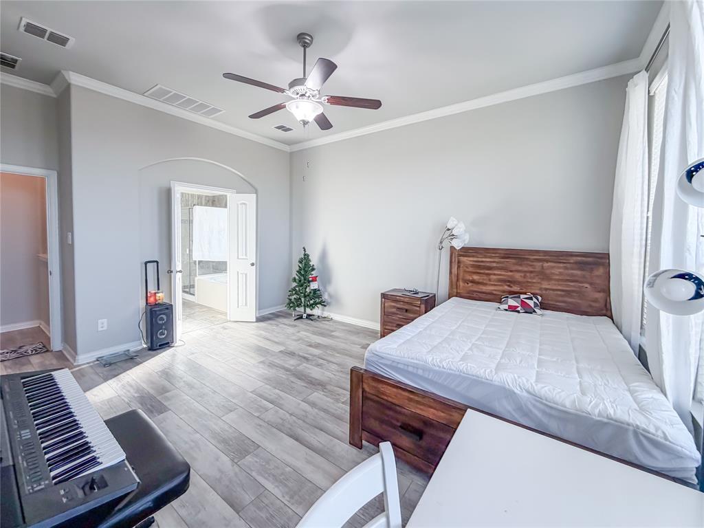 328 Callaghan Drive Fate, TX 75189 - Photo 12 of 37 a living room with furniture and a chandelier