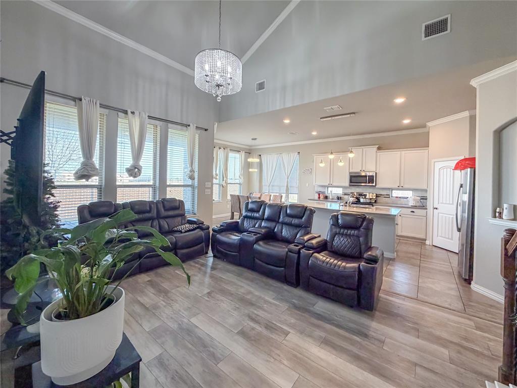 328 Callaghan Drive Fate, TX 75189 - Photo 18 of 37 a living room with furniture kitchen and a chandelier